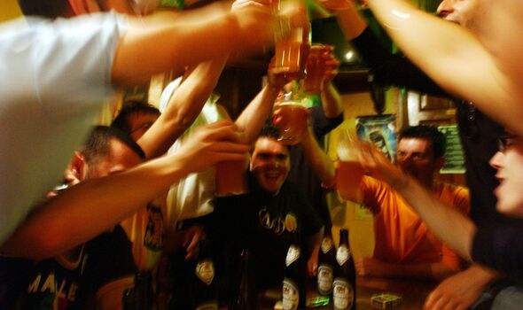 toast with glasses of beer in a pub during a school trip to Strasbourg