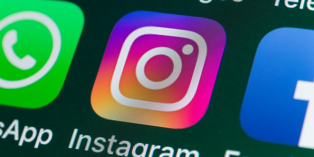 The buttons of the photo app Instagram, surrounded by WhatsApp, Facebook, Messages and other apps on the screen of an iPhone.