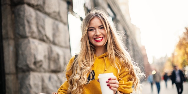 Woman smiles in photo.