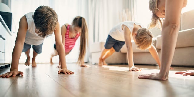 Mother with kids exercising at home