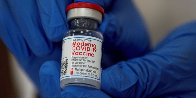 An employee shows the Moderna COVID-19 vaccine at Northwell Health's Long Island Jewish Valley Stream hospital in New York, U.S., December 21, 2020.