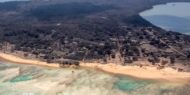 In this photo provided by the New Zealand Defense Force, volcanic ash covers rooftops and vegetation in an area of Tonga, Monday, Jan. 17, 2022. (CPL Vanessa Parker/NZDF via AP, File)