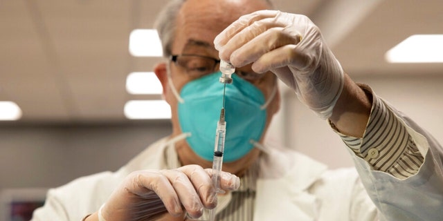 CVS pharmacist Gerard Diebner prepares the COVID-19 vaccine for the nursing home residents at Harlem Center for Nursing and Rehabilitation, a nursing home facility, on Jan. 15, 2021, in the Harlem neighborhood of New York City.