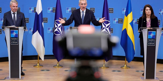 NATO Secretary General Jens Stoltenberg, center, participates in a media conference with Finland's Foreign Minister Pekka Haavisto, left, and Sweden's Foreign Minister Ann Linde, right, at NATO headquarters in Brussels on Jan. 24.