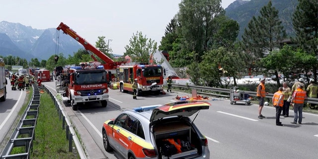 This video grab shows firemen and rescue helpers working next to a derailed train on June 3, 2022, in Burgrain near Garmisch-Partenkirchen, southern Germany.