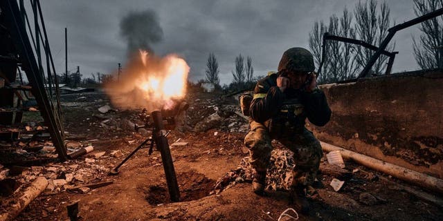A Ukrainian soldier fires a mortar at Russian positions in Bakhmut, in the Donetsk region of Ukraine, Nov. 10, 2022.  