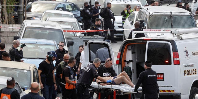 A person is wheeled on a stretcher at a scene where a suspected incident of shooting attack took place, police spokesman said, just outside Jerusalem's Old City January 28, 2023.