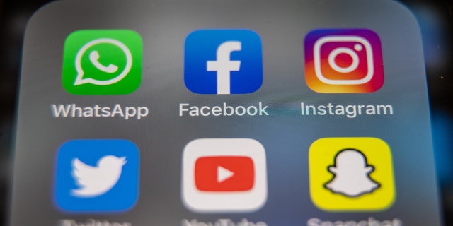 In this photo illustration, the logos of Facebook, WhatsApp and Instagram are displayed on a smartphone screen March 14, 2022, in Glastonbury, England. 