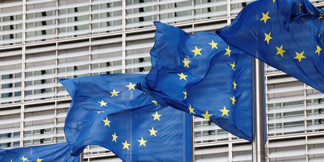 European Union flags are seen outside the EU Commission headquarters in Brussels, Belgium, on Sept. 28, 2022. 