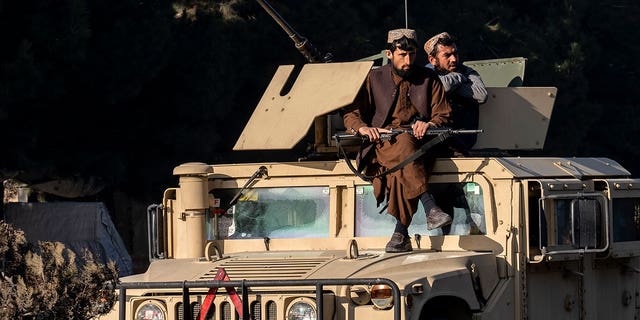 Taliban fighters stand guard at the site of an explosion, near the Interior Ministry, in Kabul, Afghanistan, Sunday, Jan. 1, 2023. A bomb exploded near a checkpoint at Kabul's military airport Sunday morning killing and wounding several people, a Taliban official said, the first deadly blast of 2023 in Afghanistan. 