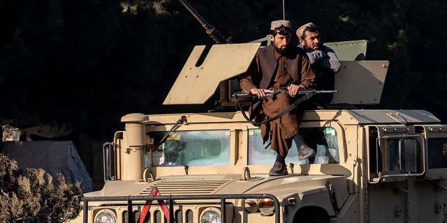 Taliban fighters stand guard at the site of an explosion, near the Interior Ministry, in Kabul, Afghanistan, Sunday, Jan. 1, 2023. A bomb exploded near a checkpoint at Kabul's military airport Sunday morning killing and wounding several people, a Taliban official said, the first deadly blast of 2023 in Afghanistan.